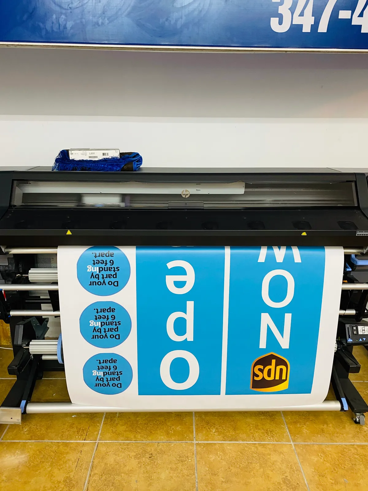 Wide-format printer producing custom vinyl signage in NYC shop