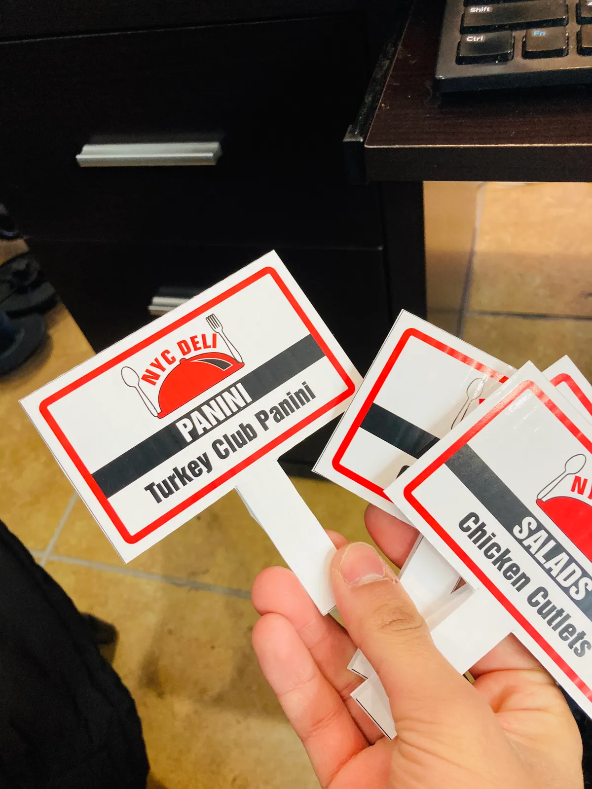 Printed deli menu tags and small signs for NYC restaurant