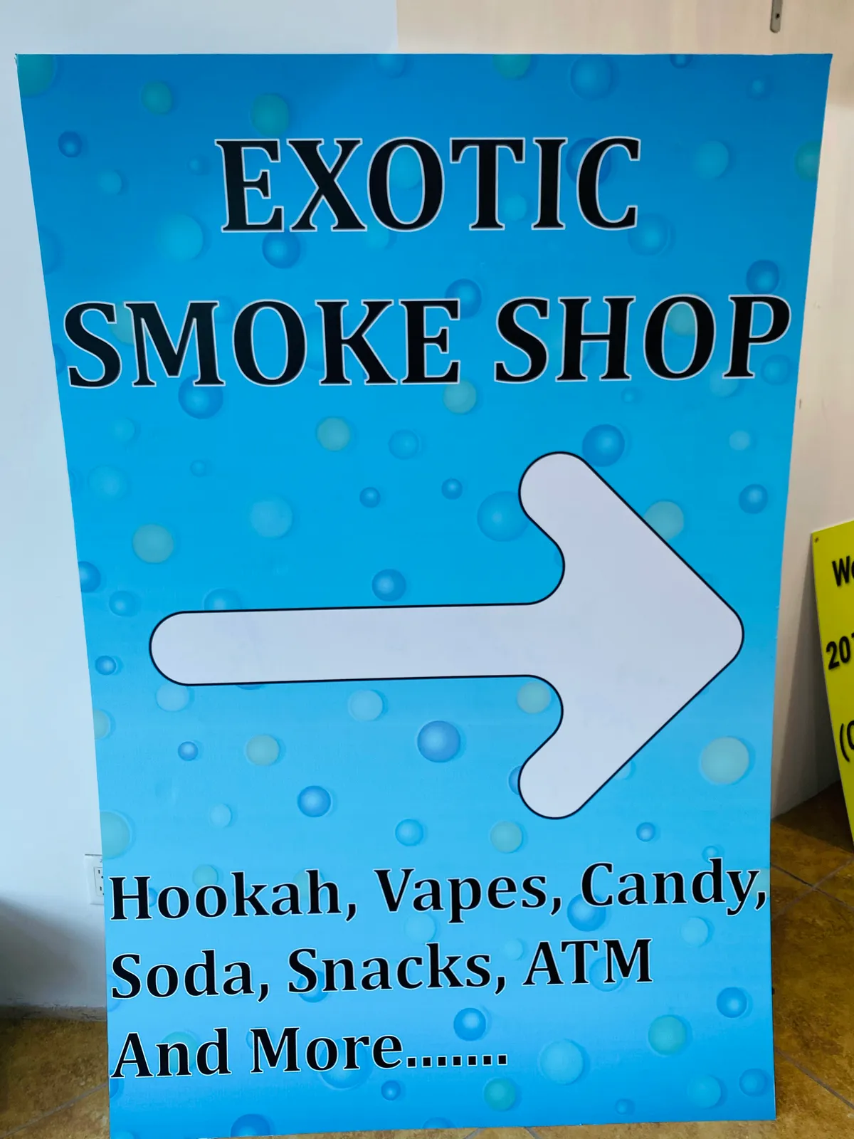 Smoke Shop directional arrow sign for New York storefront