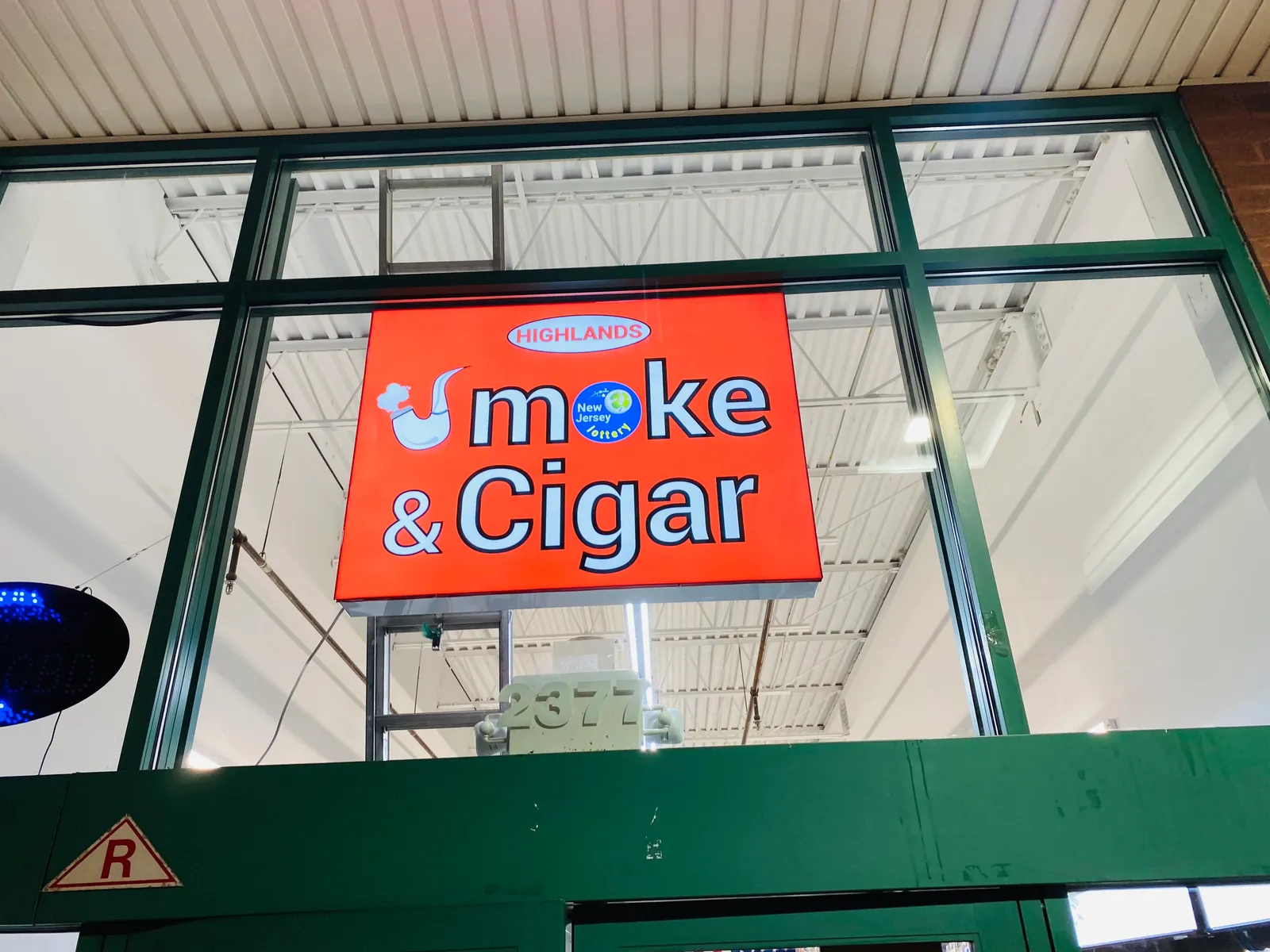 Smoke & Cigar illuminated storefront sign in New York