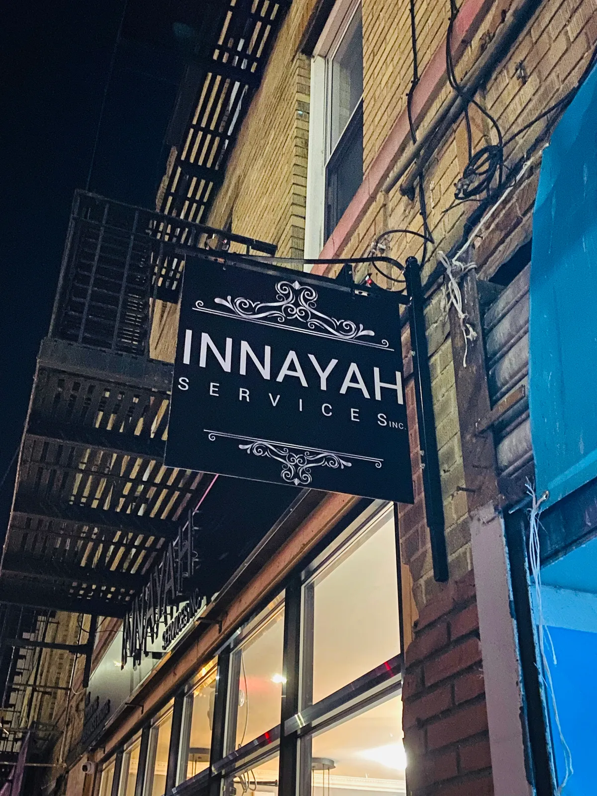 Innayah Services projecting blade sign mounted on NYC building