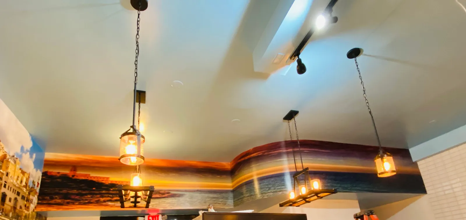 Sunset ocean ceiling mural installed in New York restaurant